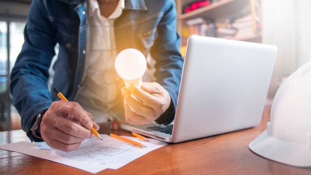 Engineer designs the construction of modern houses or buildings to energy-saving houses. Reduce emissions and consider the environment.