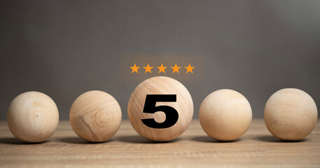 The concept of service satisfaction Smiley face ball with 5 star rating placed on wooden table...