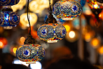 Fototapeta premium Turkey. Market With Many Traditional Colorful Handmade Turkish Lamps And Lanterns. Lanterns Hanging In Shop For Sale. Popular Souvenirs From Turkey.