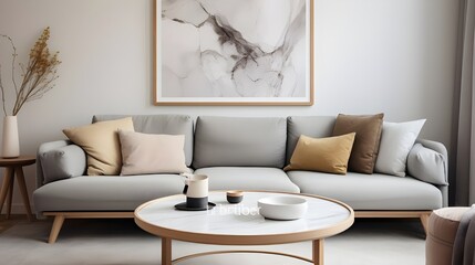 Round golden coffee table with marble stone top near gray curved sofa against beige wall with big art poster frame. Minimalist Scandinavian home interior design of modern living room. Generate AI 