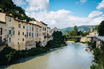 Fototapeta na wymiar Overhanging houses facades over the Drome river in the medieval village of Pontaix in the South of France (Drome)
