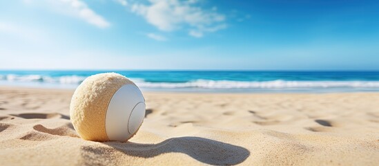Fototapeta na wymiar Beach tennis ball on sand representing summer sport Used for poster cards headers website and app