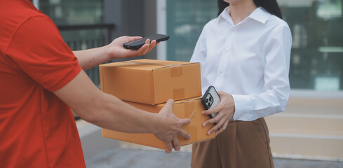 Asian Woman Receiving Product from delivery man at Home, Young Owner Woman Order Product from...