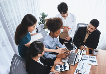 Multiracial analyst team use BI Fintech software to analyze financial data on meeting table....