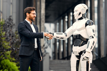 Robot with businessmen on the street near the building