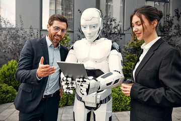 Robot with businessmen on the street near the building