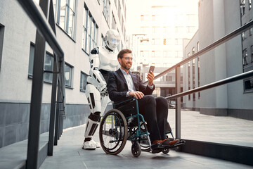 A robot carries a wheelchair with a sick man