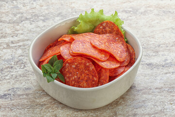 Sliced pepperoni sausage in the bowl