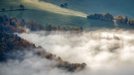 Landscape of foggy valley in an autumn morning. The Sulov Rocks, national nature reserve in northwest of Slovakia, Europe.