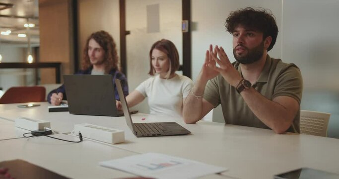 Business team discussing innovative ideas and plans. Multiracial team brainstorm late at night in modern office.