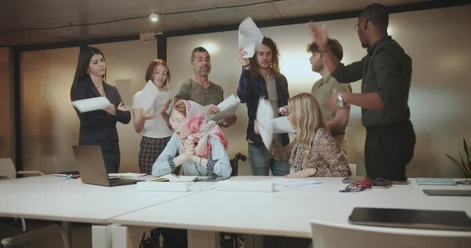 Businesspeople throwing paperwork at the office after they started arguing and confronting ideas or opinions, they are having misunderstandings.