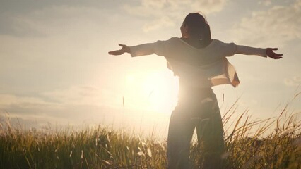 Happy smiling young woman enjoying nature. Young asian woman having fun in the meadow. freedom concept. Sunset