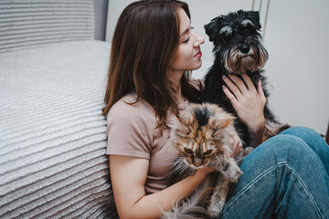dog and a cat in the hands of their owner