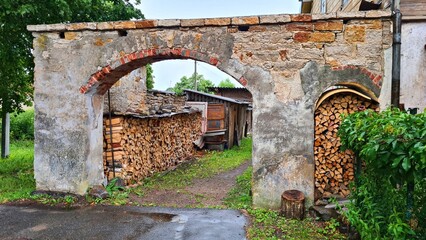 Fototapeta premium Stacked chopped wood is prepared for the stove in the village for the winter