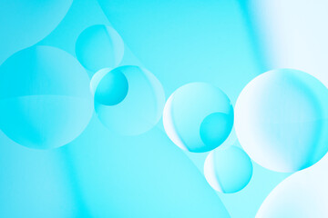 Macro photo with circles oil droplets water surface. Abstract blue and pink background with oil bubbles.