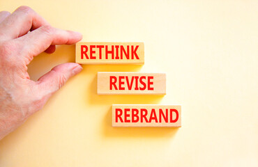 Rethink revise rebrand symbol. Concept word Rethink Revise Rebrand on beautiful block. Beautiful white table white background. Business brand motivational rethink revise rebrand concept. Copy space.