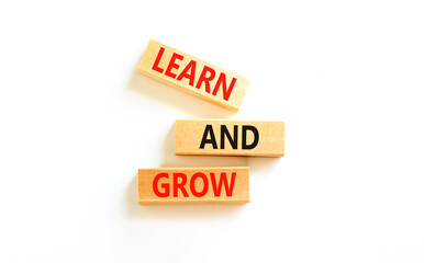 Learn and grow symbol. Concept word Learn And Grow on beautiful wooden block. Beautiful white table white background. Business, education learn and grow concept. Copy space.