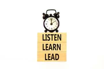 Listen learn lead symbol. Concept word Listen Learn Lead on beautiful wooden block. Black alarm clock. Beautiful white table white background. Business, education listen learn lead concept. Copy space