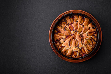 Delicious sweet aromatic homemade pie with ripe plums