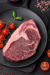 Fresh raw beef striploin steak with salt, spices and herbs