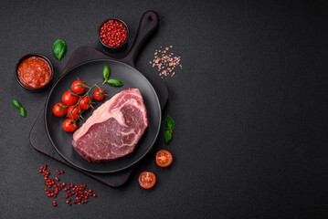 Fresh raw beef striploin steak with salt, spices and herbs