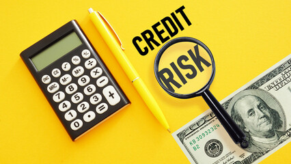 Credit risk analysis is shown using the text and photo of the magnifying glass and calculator