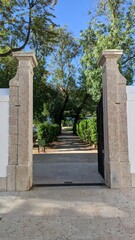 Fototapeta na wymiar Large tall narrow gate entrance to the backyard garden
