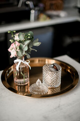 Beautiful view on vintage metallic tray, transparent old fashioned vase with macarons and flowers bouquet