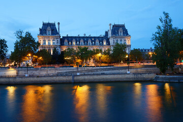 Fototapeta na wymiar City Hall of Paris across Seine river at night, France.