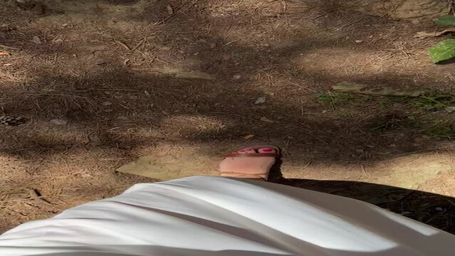 Female feet in sandals climbing natural steps in Tipasa, Algeria