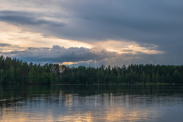 Dramatic sunset clouds on beautiful lake scenery. Finnish nature landscape.