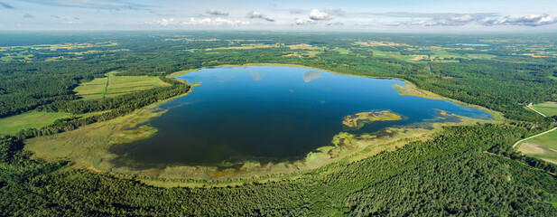 Fototapeta na wymiar Aerial view of a lake in the forests of Lithuania, wild nature. The name of the lake is 