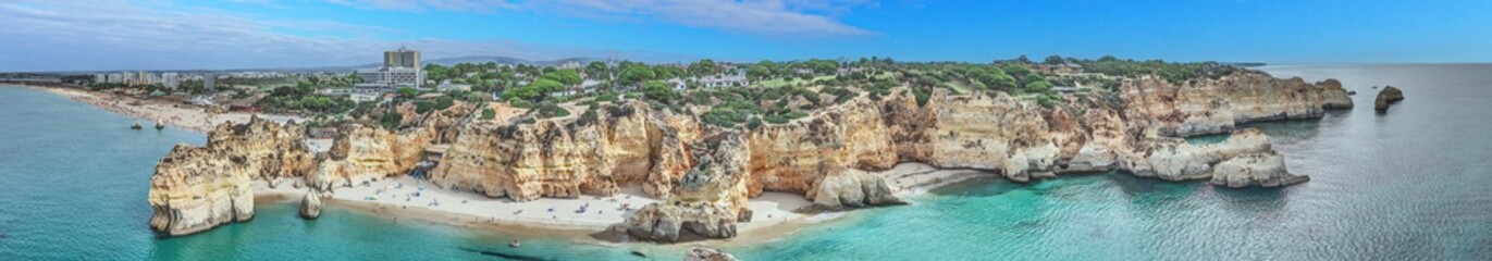Panoramic drone picture over Praia do Marinha beach in Portuguese Algarve during daytime