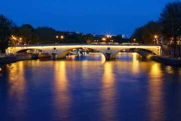 Night view of Louis-Philippe bridge across Seine river , Paris, France.
