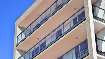 Modern luxury residential building. Modern apartment building on a sunny day. Facade apartment building  with a blue sky. 