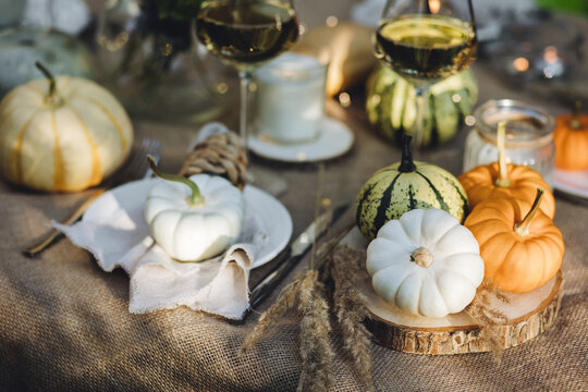 Cozy Fall Table Decoration For Thanksgiving Family Dinner Or Romantic Autumn Wedding Outdoors With Small Pumpkins, Candles. White Wine. Countryside Style, Cottage Core, Beautiful Elegant Setting