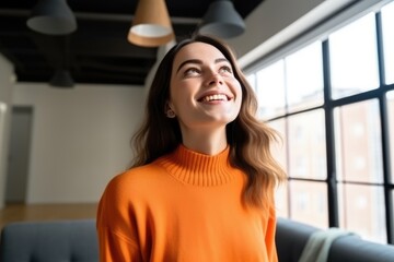 Joyful Woman in Modern Apartment: Professional, Beautiful, and Stylish in Orange Sweater