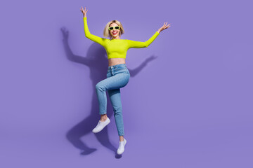 Full length photo of positive girl wear lime trendy clothes enjoying weekend celebration empty space isolated on purple color background