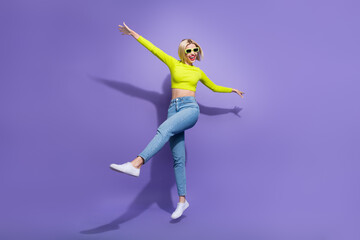Full length photo of cheerful lovely girl wear trendy outfit summer glasses enjoying weekend party isolated on purple color background