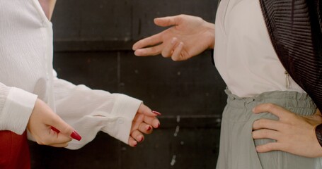 Close-up gesturing hand as emphasis, two persons communication, conveying a message. Female...