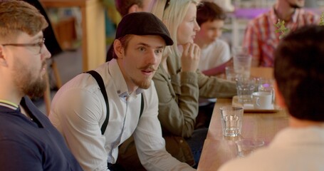 Person in club to improve public speaking, presentation. Active gesticulation, showing palms to opponent. Debate Clubs background. Man practice presenting arguments, open to feedback. People in cafe.