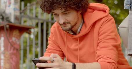 Man looking at smartphone screen, reading, composing, managing emails, access social media platforms, post updates, check notifications. using GPS map applications for directions. Checking Social Apps