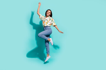 Photo of positive optimistic girl wear stylish clothes jumping up rejoice seasonal discount empty...