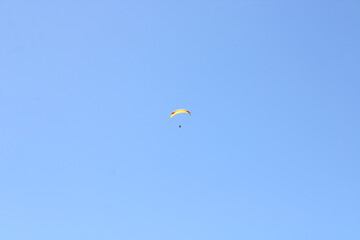 parachutist floating in the blue sky