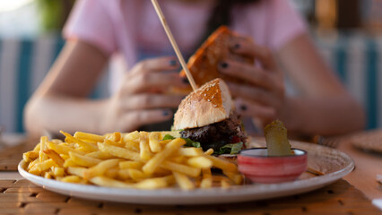 a person eating a hamburger