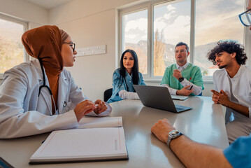A medical team of doctors discussing at a meeting in the conference room.