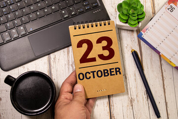 October 23. Date of October month. Diamond wood table for background.