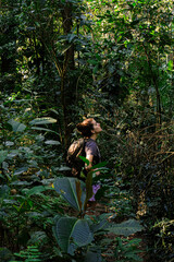 Naklejka na ściany i meble Female tourist with backpack exploring the jungle. Brazil ilha grande