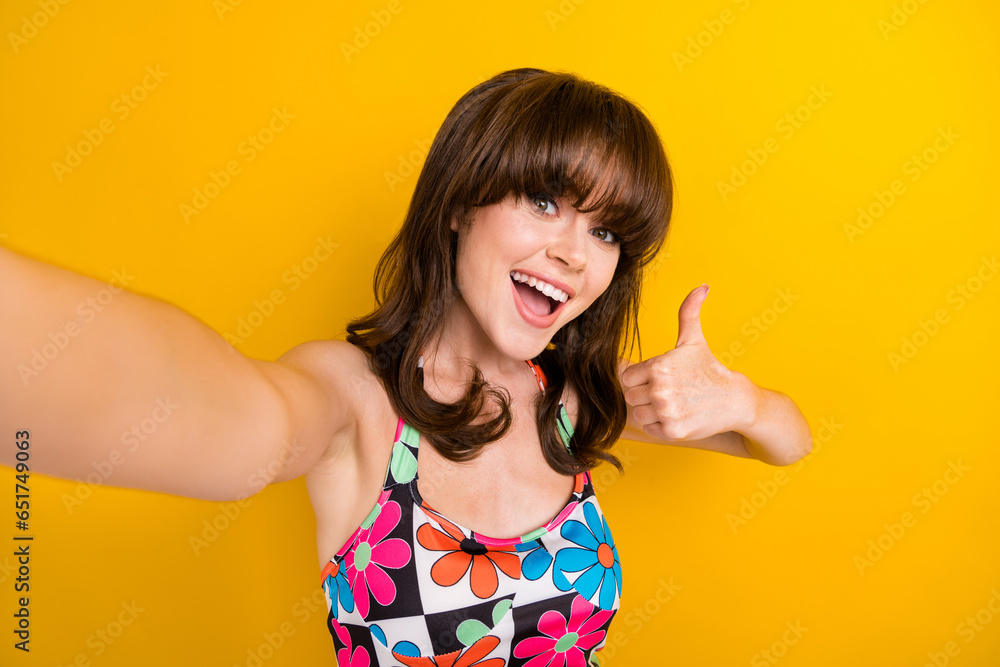 Wall mural Photo of sweet confident lady wear flower print clothes showing thumb up recording video vlog isolated yellow color background