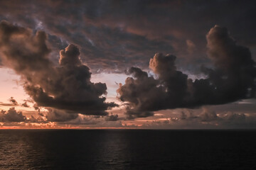 Dramatic cloud sky during sunrise/sunset over the North Atlantic Ocean and Caribean Sea looks like...